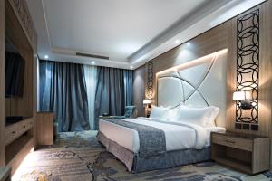 a hotel room with a large bed and a television at Mirnian Hotel in Jeddah