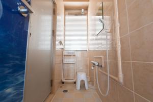 a bathroom with a toilet, sink, and shower at Guest House Grand Naha in Naha