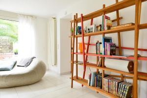 a room with a book shelf filled with books at L’appartement - Jardin Secret in Marseille