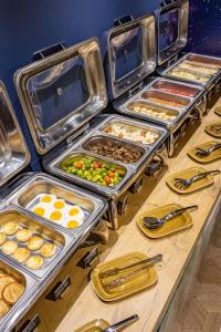 a buffet line with many different types of food at ibis Styles Chelyabinsk in Chelyabinsk