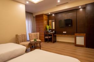 TV a/nebo společenská místnost v ubytování Hotel Palm International