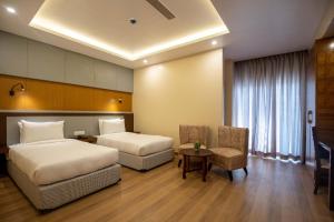 Postel nebo postele na pokoji v ubytování Hotel Palm International
