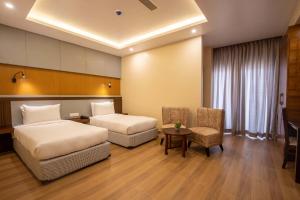 Postel nebo postele na pokoji v ubytování Hotel Palm International