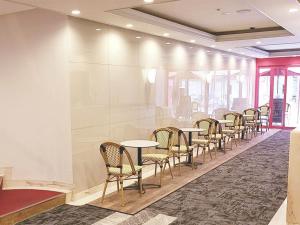 a row of tables and chairs in a room at Hotel Neo Rouge in Tokyo