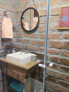 a bathroom with a sink and a mirror at Bangalô do Rio - Timbé do Sul in Timbe do Sul +43 photos