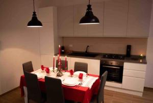 a kitchen with a table with a red table cloth at La casa dell'Aquila - Eagle house in Preturo