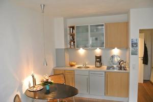 a kitchen with a table and a dining room at Wohnung Tide in Hörnum