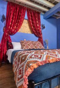 a bedroom with two beds with red curtains at Fatma Hanoum boutique hotel in Rhodes Town
