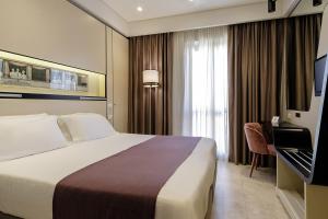 Postel nebo postele na pokoji v ubytování Hotel Smeraldo
