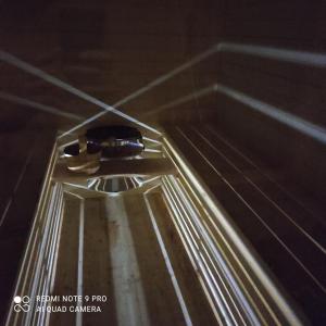 a bottle of wine sitting on top of a table at Domek pod chałpom sauna & bania in Gliczarów