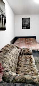 a bedroom with a bed and a couch in it at Квартира на проспекте Поля 127 in Dnipro