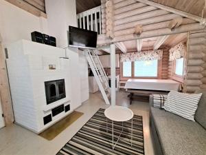 a living room with a fireplace and a tv at Sarkkila in Kalajoki