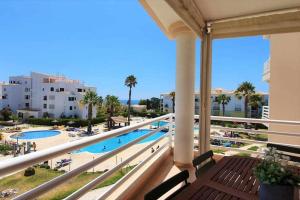 a balcony with a view of a pool and buildings at Estrela do Oceano in Portimão +28 photos