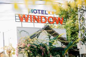 a sign for a hotel window with flowers at Window 2 Hotel in Kon Tum