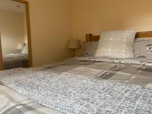 a bedroom with a large bed with a mirror at Ye Old Tack Room in Stafford