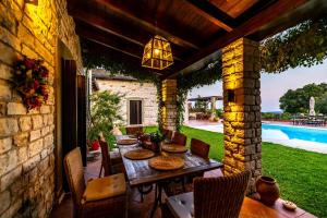 a patio with a table and chairs and a pool at Patriko Estate in Epirus in Térovon