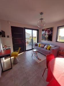 a living room with a couch and a table at AU GRAIN D'ORGE in Échiré