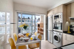 a kitchen with a table with chairs and a dining room at Numar Residence Villa Z in Manta Rota