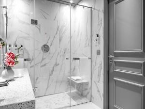 a shower with a glass door in a bathroom at Sofitel Roma Villa Borghese in Rome
