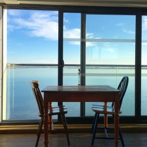 a table and two chairs in front of a large window at The Royal George in Appledore