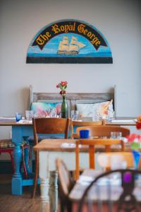 a dining room with aasy royal seafood sign on the wall at The Royal George in Appledore