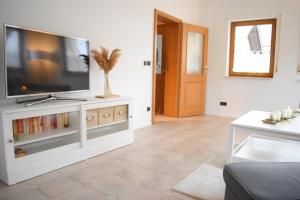 a living room with a flat screen tv on a entertainment center at OB Ferienwohnung Sensbachtal in Untersensbach