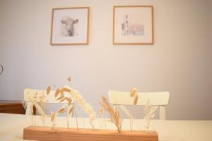 a table with two chairs and two pictures on the wall at OB Ferienwohnung Sensbachtal in Untersensbach +24 photos