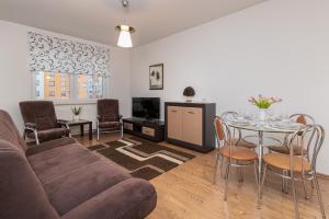 a living room with a couch and a table at Karawela Gdańsk Apartments by Renters in Gdańsk