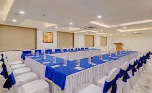 a banquet hall with blue and white tables and chairs at Click Collection Jaipur in Jaipur
