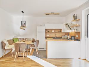 a kitchen and dining room with a table and chairs at Sunlodge Oeblarn Top C3 Schladming-Dachstein in Öblarn