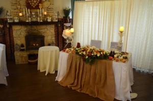 a room with two tables with flowers and a fireplace at Motel Chalet in Vita-Pochtovaya