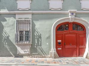 a red door on the side of a building at limehome Bamberg Keßlerstraße in Bamberg