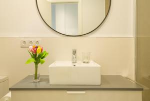 a bathroom with a white sink and a mirror at Hercot Canteras Beach,Sun,City WIFI free in Las Palmas de Gran Canaria