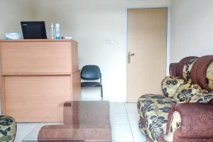 a room with two chairs and a desk and a chair at Griya De Riz Syariah Mitra RedDoorz in Jambi