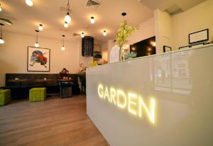 a restaurant with a sign that reads garden at Garden Hotel in Zagreb