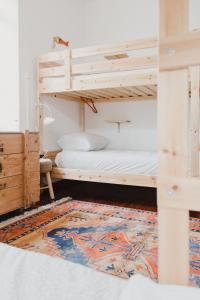 a bedroom with a bed and a desk at Jaca Hostel Porto da Cruz in Porto da Cruz