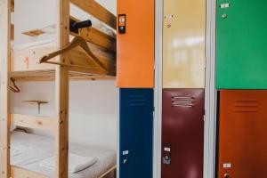 a room with two bunk beds and a ladder at Jaca Hostel Porto da Cruz in Porto da Cruz