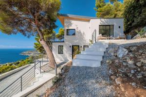a house on the hill with a view of the ocean at Villa Vista Mare by iVillamia com in Villefranche-sur-Mer