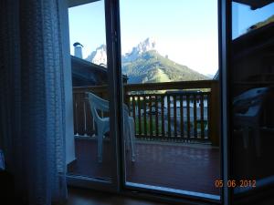 a view of a mountain from a screened in porch at Casa Brugnara in Pozza di Fassa