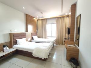 Postel nebo postele na pokoji v ubytování Hotel Pragati
