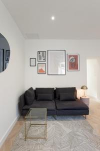 a living room with a couch and a table at La Nuit Arlésienne - Exclusive apartments in Arles