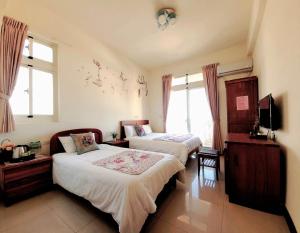 Postel nebo postele na pokoji v ubytování YehSir B&B