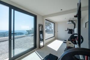 a gym with windows and a view of the ocean at Villa Vista Mare by iVillamia com in Villefranche-sur-Mer