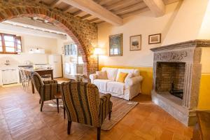 a living room with a white couch and a fireplace at Podere San Selvatico in Città della Pieve