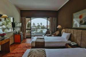 a hotel room with a couch and a bed at Basma Hotel Aswan in Aswan