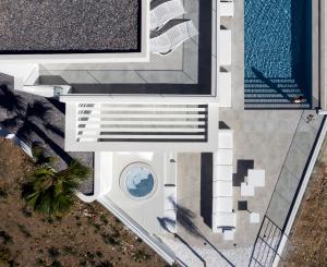 an overhead view of a building with a swimming pool at Ode Iconic Residence, forever in blue - Best Villa, By ThinkVilla in Bali