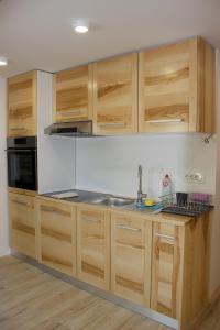 a kitchen with wooden cabinets and a sink at Malina in Vransko