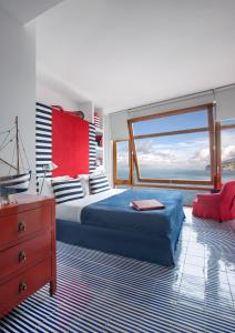 a bedroom with a bed with a view of the ocean at Maison La Minervetta in Sorrento