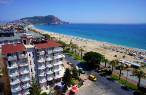 a view of a beach with a building and the ocean at Kleopatra Melissa Hotel in Alanya