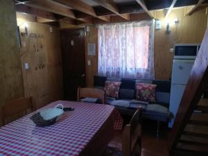 a living room with a table and a couch at Cabañas Cadiz Valdivia in Valdivia +70 photos